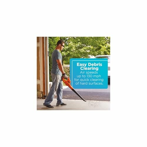 Person using a leaf blower for easy debris clearing.