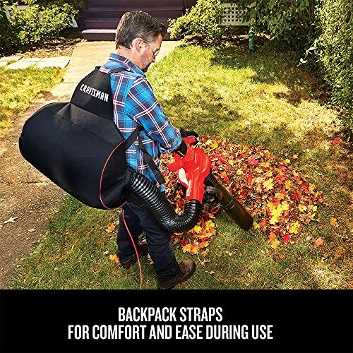 Man using a backpack leaf blower on fallen leaves.