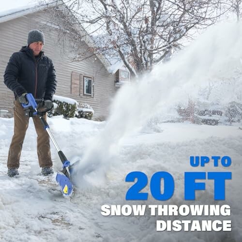 Man using a snow blower to clear snow from a driveway.