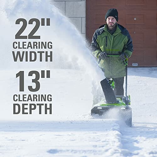 Person using a snow blower on a snowy driveway, showing 22 inch clearing width and 13 inch clearing depth.